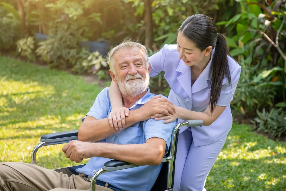 Elderly man smiling with caregiver