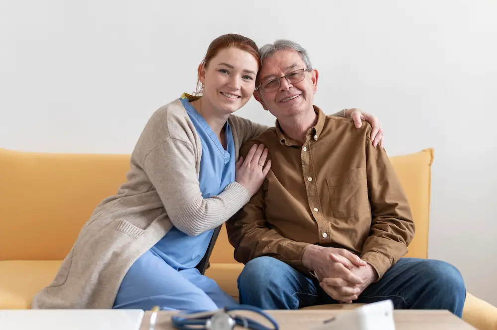 Caregiver supporting an elderly woman at home