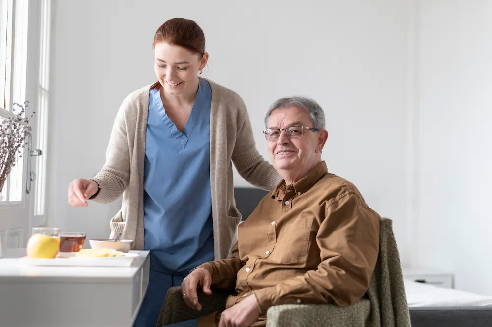 Caregiver supporting an elderly woman at home