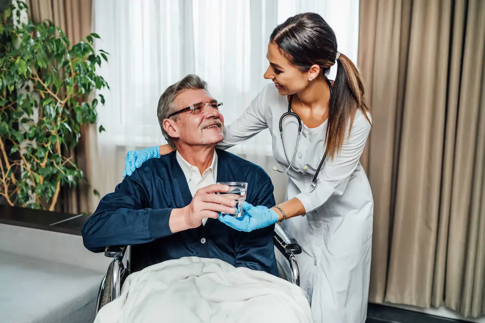 Home care professional helping a senior man with a task