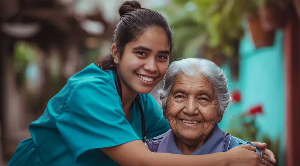 Caregiver and elderly man smiling on a porch swing