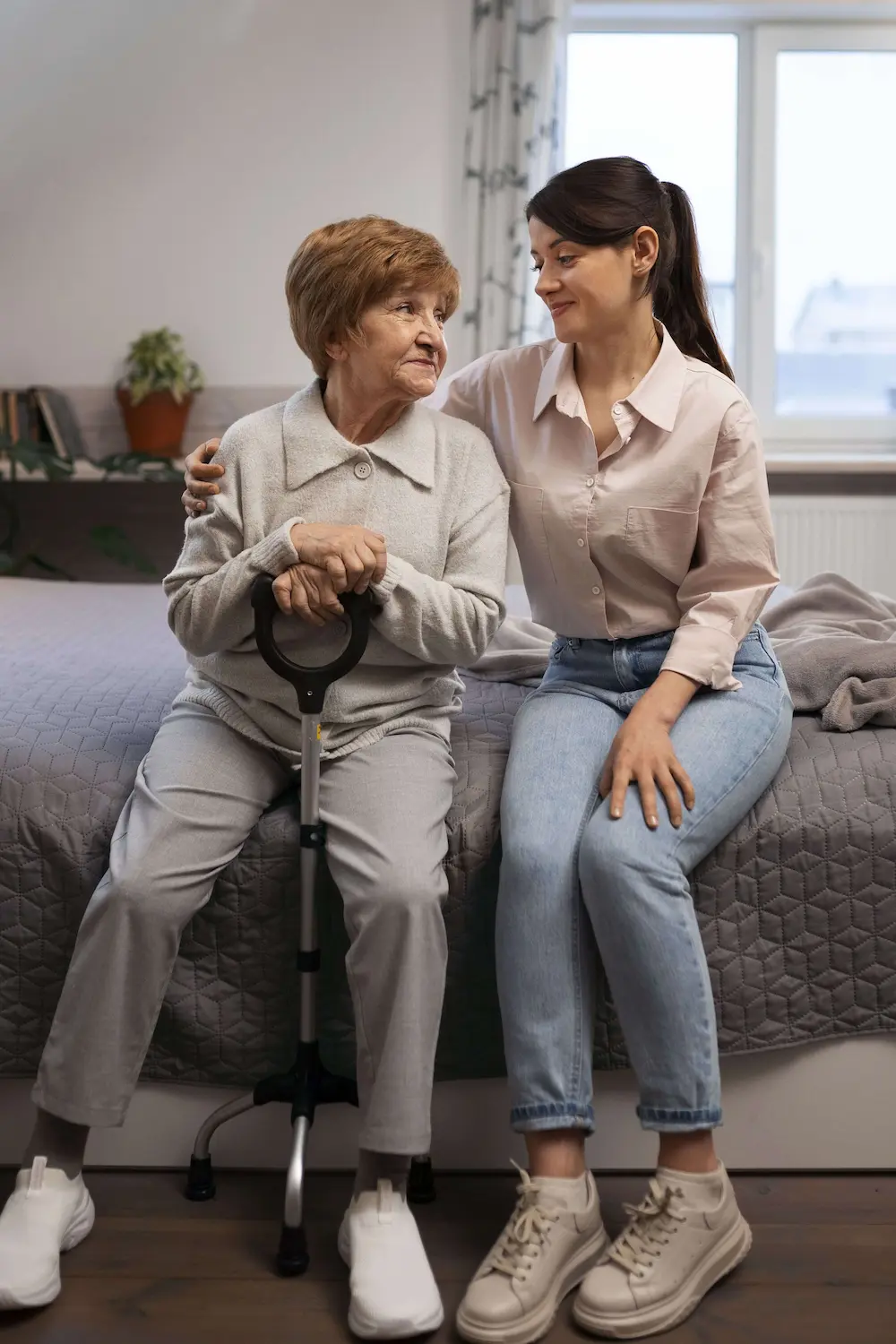 Elderly woman smiling with caregiver